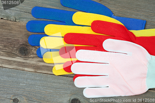 Image of four colored construction gloves