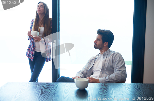 Image of relaxet young couple drink first morning coffee