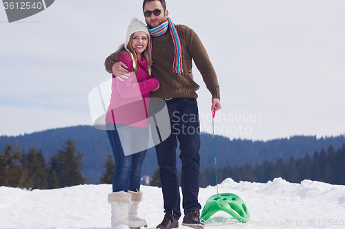 Image of happy young couple having fun on fresh show on winter vacation