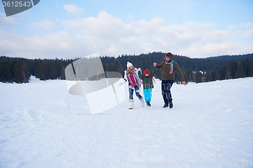 Image of happy family playing together in snow at winter