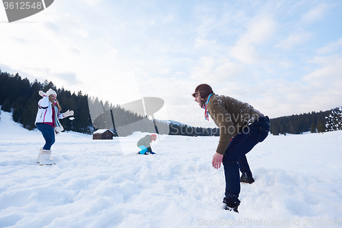 Image of happy family playing together in snow at winter