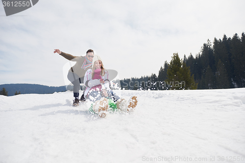 Image of happy young couple having fun on fresh show on winter vacation