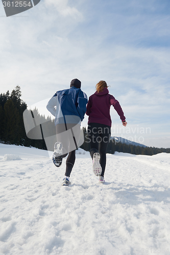 Image of couple jogging outside on snow