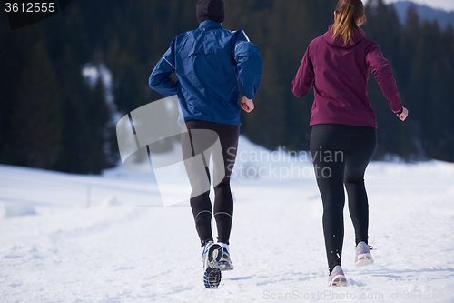 Image of couple jogging outside on snow