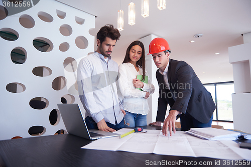 Image of couple buying new home with real estate agent