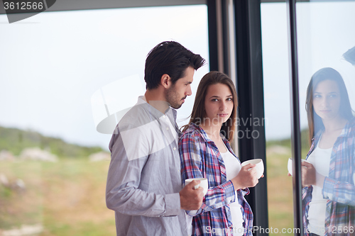 Image of relaxet young couple drink first morning coffee