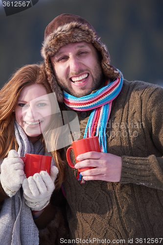 Image of couple drink warm tea at winter