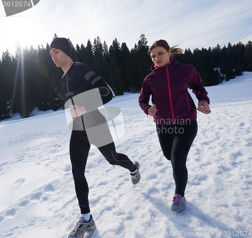 Image of couple jogging outside on snow