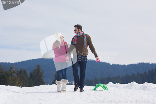 Image of happy young couple having fun on fresh show on winter vacation