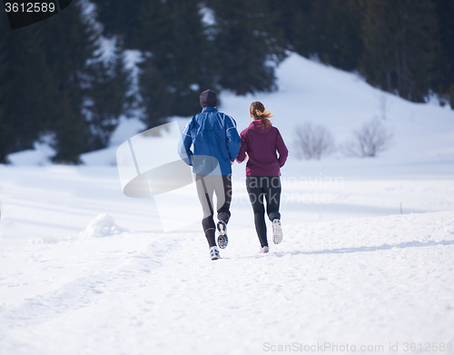 Image of couple jogging outside on snow
