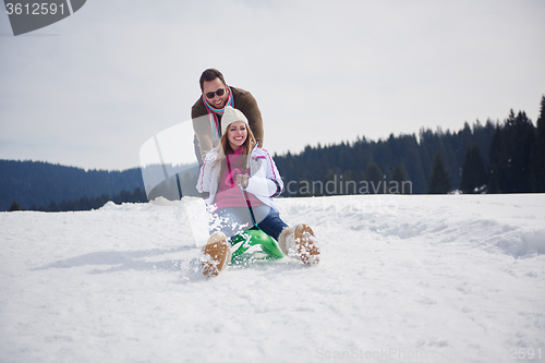 Image of happy young couple having fun on fresh show on winter vacation