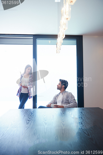 Image of relaxet young couple drink first morning coffee