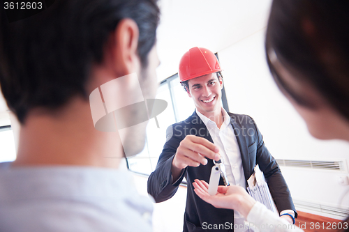 Image of couple buying new home with real estate agent