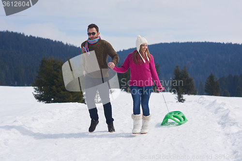 Image of happy young couple having fun on fresh show on winter vacation