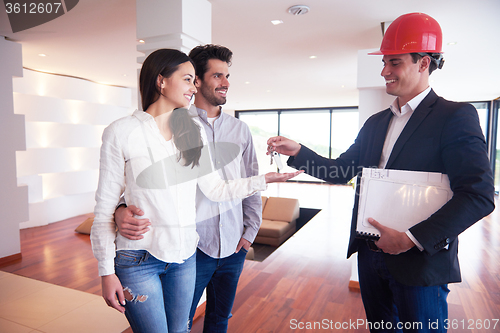Image of couple buying new home with real estate agent