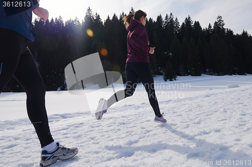Image of couple jogging outside on snow