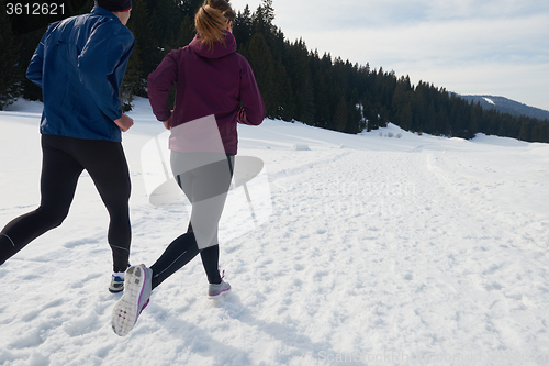 Image of couple jogging outside on snow