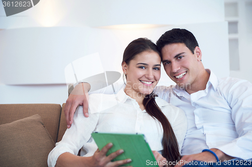 Image of couple at modern home using tablet computer