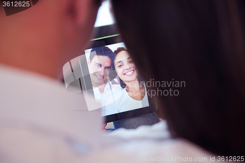 Image of couple at modern home using tablet computer