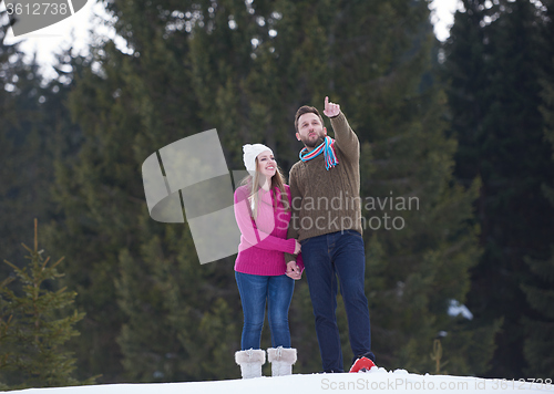 Image of couple having fun and walking in snow shoes