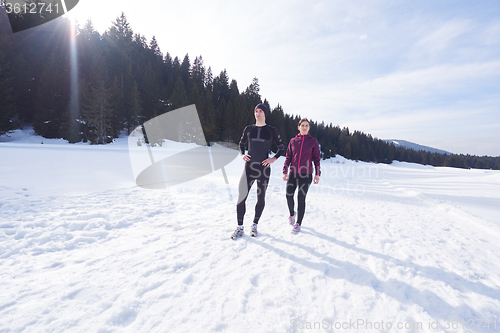 Image of couple jogging outside on snow