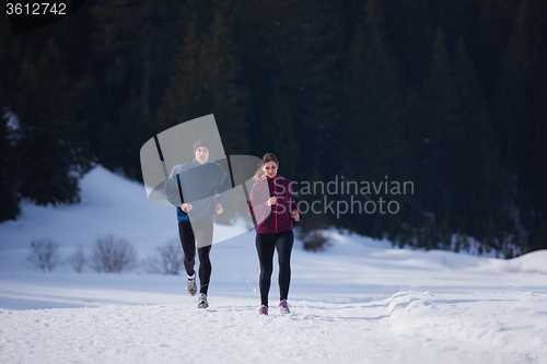 Image of couple jogging outside on snow