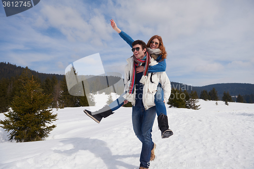 Image of happy young couple having fun on fresh show on winter vacation