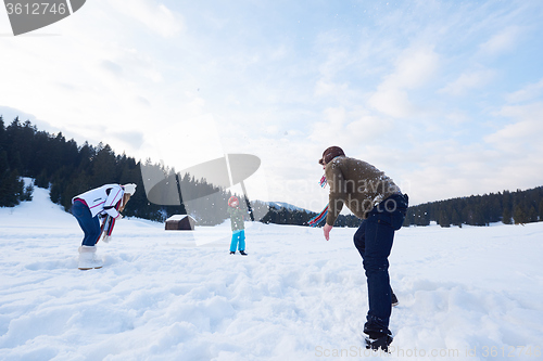 Image of happy family playing together in snow at winter