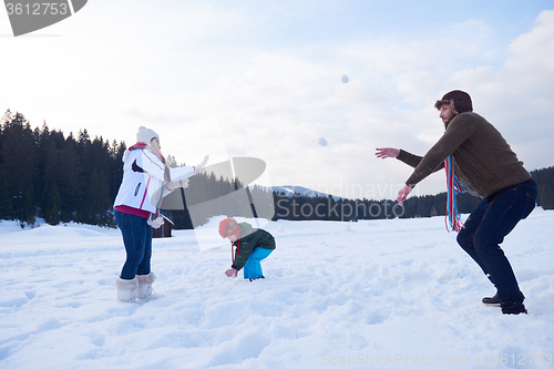 Image of happy family playing together in snow at winter