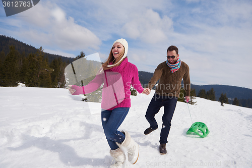 Image of happy young couple having fun on fresh show on winter vacation