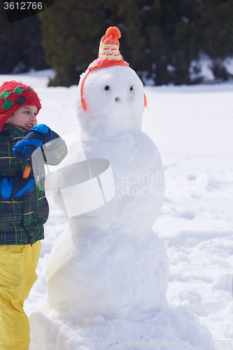 Image of boy making snowman