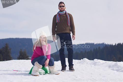 Image of happy young couple having fun on fresh show on winter vacation