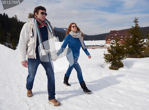 Image of happy young couple having fun on fresh show on winter vacation