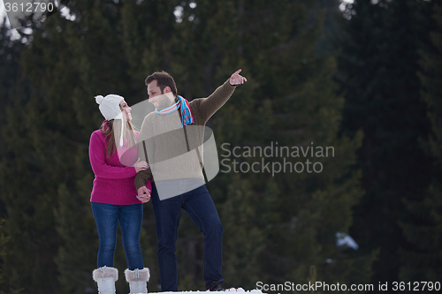 Image of couple having fun and walking in snow shoes