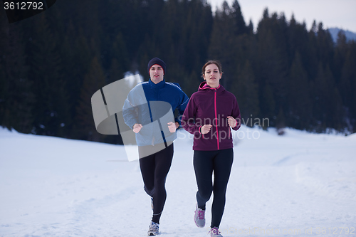 Image of couple jogging outside on snow