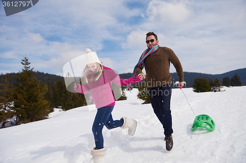 Image of happy young couple having fun on fresh show on winter vacation