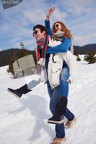 Image of happy young couple having fun on fresh show on winter vacation