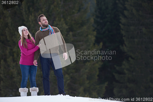 Image of couple having fun and walking in snow shoes