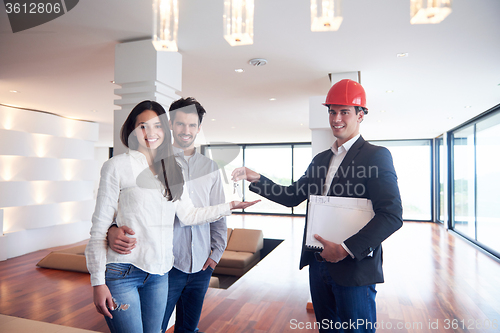 Image of couple buying new home with real estate agent