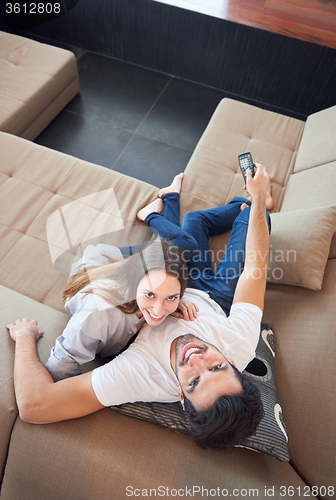Image of young couple watching tv at home