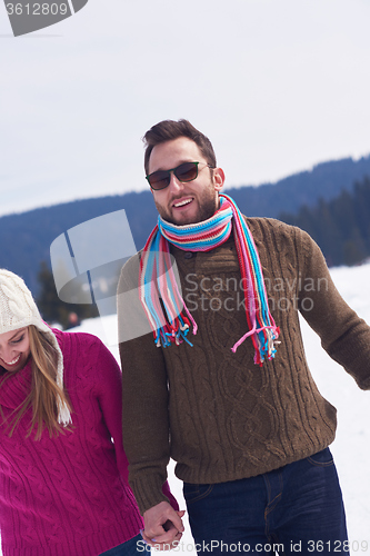 Image of happy young couple having fun on fresh show on winter vacation