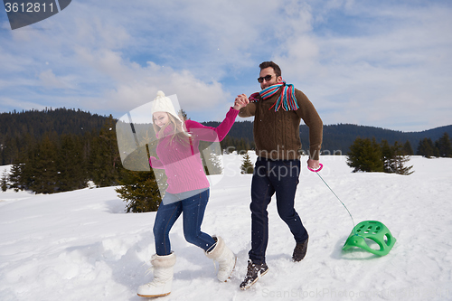 Image of happy young couple having fun on fresh show on winter vacation