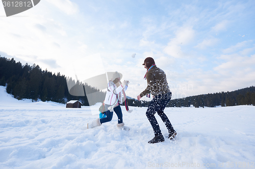 Image of happy family playing together in snow at winter