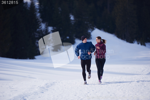 Image of couple jogging outside on snow