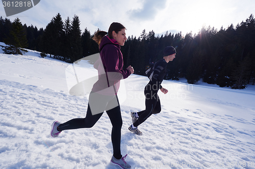 Image of couple jogging outside on snow