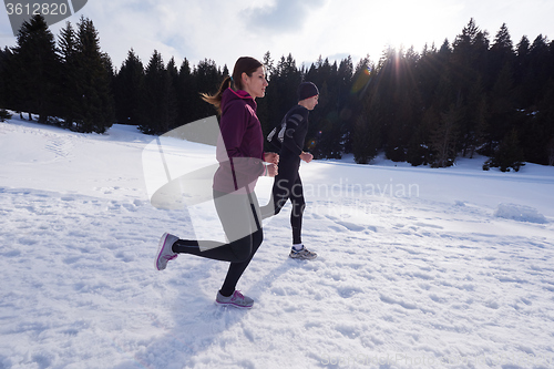 Image of couple jogging outside on snow