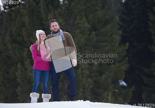 Image of couple having fun and walking in snow shoes