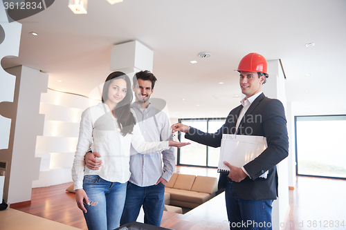 Image of couple buying new home with real estate agent