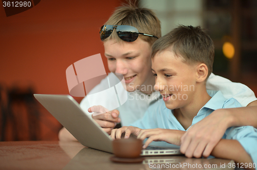 Image of brothers with laptop