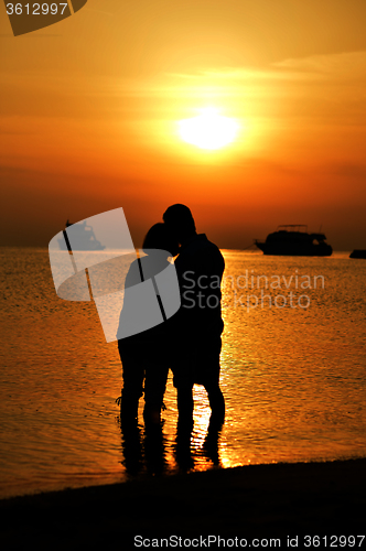 Image of  couple at sea at sunset